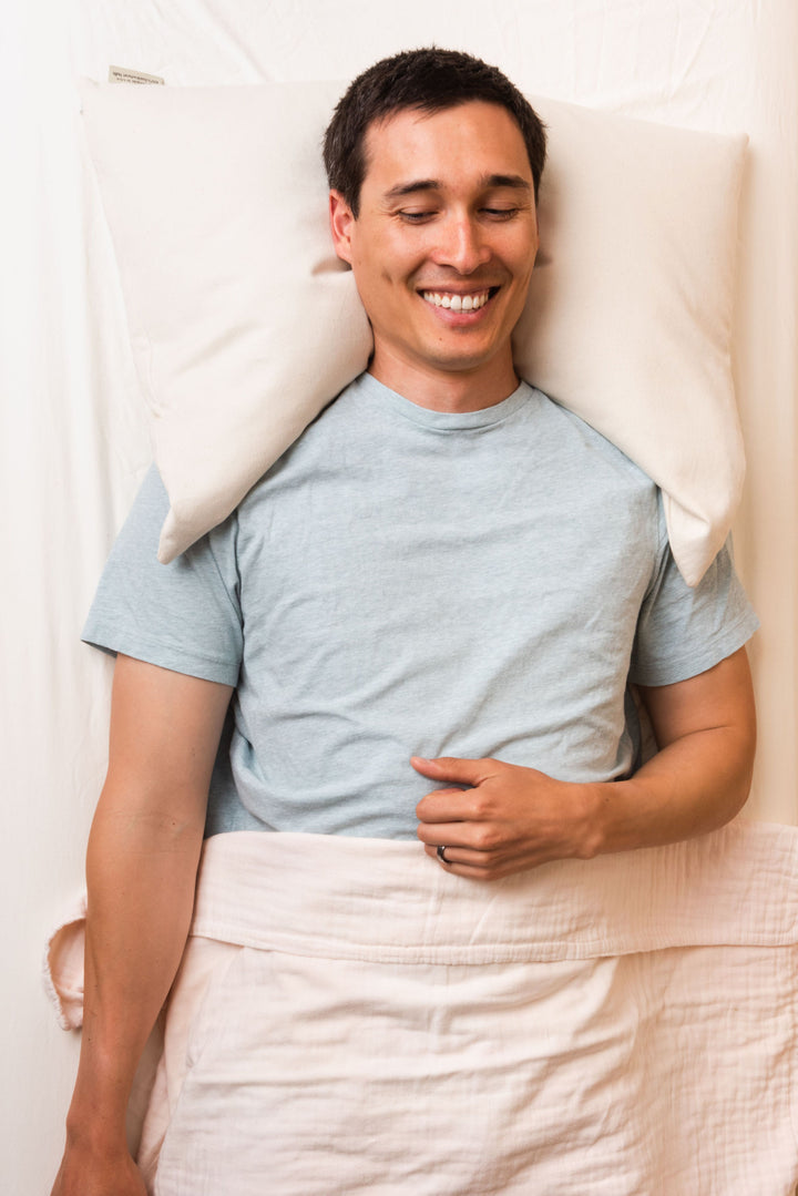 Man sleeping supported on comfycomfy curved buckwheat hull pillow