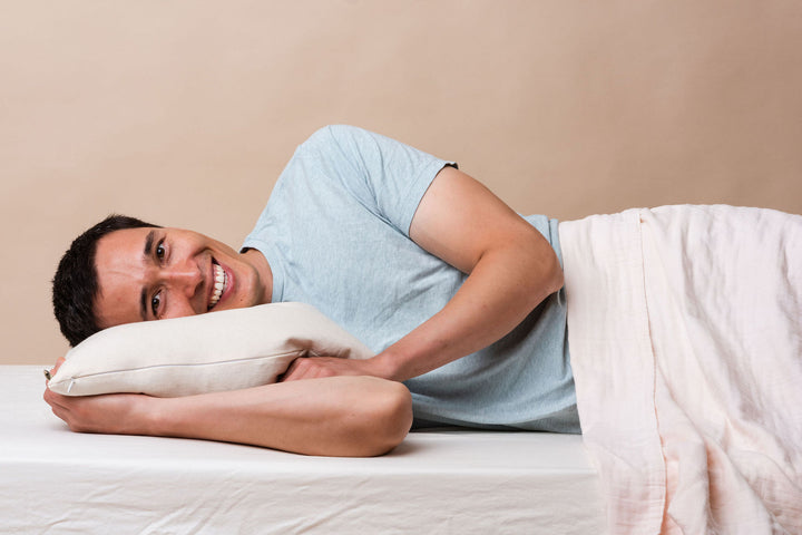 man laying on side sleeper supportive buckwheat hull pillow
