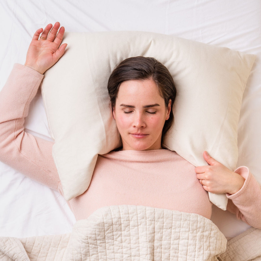 Woman on bed with ComfyCurve buckwheat pillow